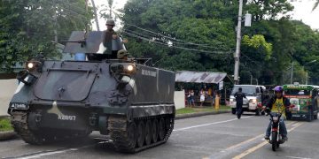 A tank stops on the side of the road as it waits for other tanks to roll into a military camp in Iligan city to reinforce Government troops who are battling Muslim militants who laid siege in Marawi city for over a week now Wednesday, May 31, 2017 in southern Philippines. Fighting continues for the second week now between Government troops and Muslim militants with casualties on both side and civilians.(AP Photo/Bullit Marquez)