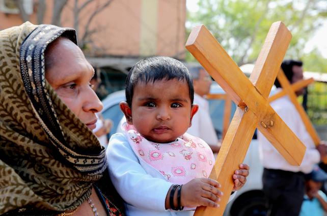 epa05906988 Christian devotees carry crosses while participating in a religious procession on the occasion of Good Friday in Bhopal, India, 14 April 2017. It is the one of the highest religious holidays observed by Christians all over the world, commemorating the crucifixion of Jesus Christ and his death at Golgotha, a central event in Christian theology.  EPA/SANJEEV GUPTA