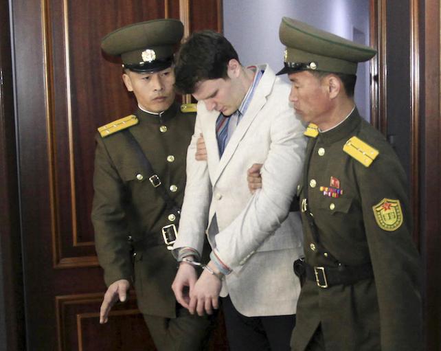 American student Otto Warmbier, center, is escorted at the Supreme Court in Pyongyang, North Korea, Wednesday, March 16, 2016. North Korea's highest court sentenced Warmbier, a 21-year-old University of Virginia undergraduate student, from Wyoming, Ohio, to 15 years in prison with hard labor on Wednesday for subversion. He allegedly attempted to steal a propaganda banner from a restricted area of his hotel at the request of an acquaintance who wanted to hang it in her church. (ANSA/AP Photo/Jon Chol Jin)