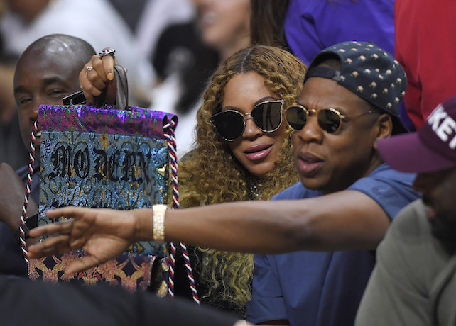 FILE - In this April 30, 2017, file photo, Beyonce and Jay Z watch during the first half in Game 7 of an NBA basketball first-round playoff series between the Los Angeles Clippers and the Utah Jazz in Los Angeles. Jay Z opened up about his relationship with Beyonce on his new album, "4:44," which was released June 30, 2017. (AP Photo/Mark J. Terrill, File)