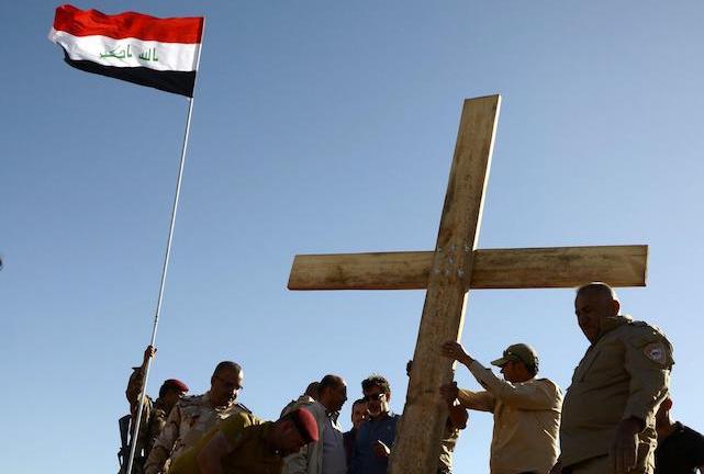 epa05926820 Muslims and Christians Iraqi civilians from Mosul raise a wooden cross near the monastery of Saint Mar Georges in Mosul, northern Iraq, 24 April 2017. (Issued 25 April 2017). A group of activists civilans from Mosul city raised a big wooden cross on the occasion of the birth of Saint Mar Georges in Mosul. It is a message of love and peaceful coexistence between communities in the city of Mosul, an Iraqi activist said.  EPA/OMAR ALHAYALI