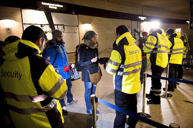 epa05087461 Security staff check IDs at Kastrups train station outside Copenhagen, Denmark, 04 January 2015. Identity checks went into effect for  travellers from Denmark to Sweden as part of measures to reduce the flow of migrants into Sweden. Passengers boarding trains, ferries or buses bound for Sweden have to show a passport or other form of valid ID card to be allowed onboard under the new rules. Transport companies are responsible for conducting the checks. Danish train operator DSB said it has set up 34 check points at the Kastrup train station that serves Copenhagen Airport, and is the last train stop before the Swedish border.  EPA/NILS MEILVANG DENMARK OUT