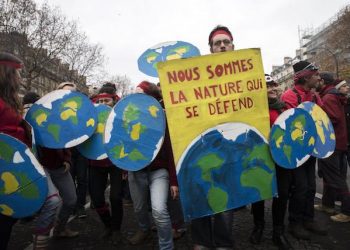 epa05066055 People using cardboard shield in the form of earth demonstrate with a poster stating 'We are Nature that defends itself', during a protest as the COP21 reaches its end in Paris, France, 12 December 2015. The 21st Conference of the Parties (COP21) is held in Paris from 30 November to 12 December aimed at reaching an international agreement to limit greenhouse gas emissions and curtail climate change.  EPA/ETIENNE LAURENT