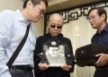 In this photo provided by the Shenyang Municipal Information Office, Liu Xia, center, wife of jailed Nobel Peace Prize winner and Chinese dissident Liu Xiaobo, holds a portrait of him during his funeral at a funeral parlor in Shenyang in northeastern China's Liaoning Province, Saturday, July 15, 2017. China says the body of Liu Xiaobo, who died this week after a battle with liver cancer, has been cremated. The government of the city of Shenyang in northeastern China, where Liu was treated, said in a briefing that the cremation took place Saturday morning in a ceremony attended by family and friends. (Shenyang Municipal Information Office via AP)