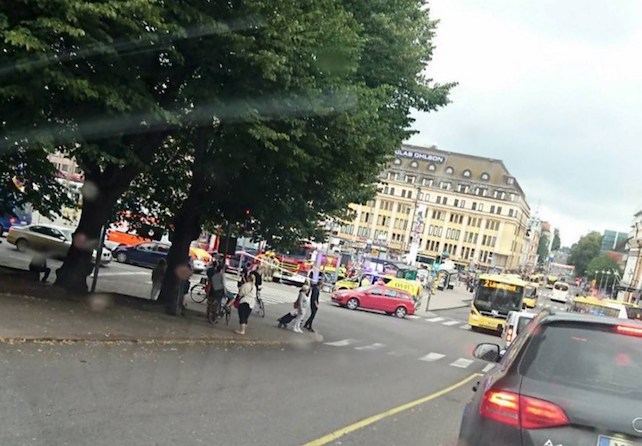 Turku Market Square on Friday, Aug. 18, 2017, with a yellow ambulance on the corner of the square (behind red car). Police in Finland say they have shot a man in the leg after he was suspected of stabbing several people in the western city of Turku. (Lehtikuva via AP)