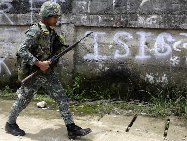 epa06005230 A Filipino government soldier walks on a street as fighting between Islamist militants and government forces continues in Marawi City, Mindanao Island, southern Philippines, 02 June 2017. According to media reports, at least 174 people have been killed in ongoing clashes between militants linked to the so-called Islamic State (IS or ISIS, ISIL) militant group and the Philippine Army in the southeastern city of Marawi. The clashes began on 23 May when a military operation failed to capture Isnilon Hapilon, the leader of the extremist group Abu Sayyaf who was being safeguarded by members of the Maute Group, both groups pledged alliance to IS. Philippine President Rodrigo Duterte declared martial law for the island of Mindanao on the same day that the conflict emerged.  EPA/FRANCIS R. MALASIG