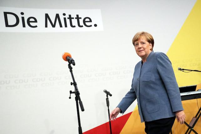 epa06225011 German Chancellor Angela Merkel of the Christian Democratic Union (CDU) steps on a stage in the late evening at the CDU election event in Berlin, Germany, 24 September 2017. According to federal election commissioner more than 61 million people were eligible to vote in the elections for a new federal parliament, the Bundestag, in Germany.  EPA/CARSTEN KOALL