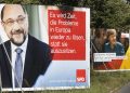 Election campaign posters of German Chancellor Angela Merkel, right, reading: "Clever, Cool-headed, Resolute  That Our Country Remains On The Course Of Success". and her challenger Martin Schulz of the Social Democrats, left, reading: " It Is Time To Solve Europe's Problems Instead Sitting On The Sidelines. "  are displayed in  a street in Berlin, Tuesday, Sept. 5, 2017. General election for a new parliament will take place in Germany on Sunday, Sept. 24, 2017. (AP Photo/Markus Schreiber)