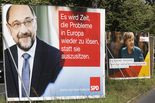 Election campaign posters of German Chancellor Angela Merkel, right, reading: "Clever, Cool-headed, Resolute  That Our Country Remains On The Course Of Success". and her challenger Martin Schulz of the Social Democrats, left, reading: " It Is Time To Solve Europe's Problems Instead Sitting On The Sidelines. "  are displayed in  a street in Berlin, Tuesday, Sept. 5, 2017. General election for a new parliament will take place in Germany on Sunday, Sept. 24, 2017. (AP Photo/Markus Schreiber)