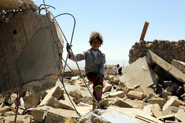 epa05522297 A Yemeni child stands over the rubble of a destroyed house targeted by an alleged Saudi-led airstrike in Bait Marran district, Sana'a province, Yemen, 03 September 2016. According to reports, at least nine Yemenis, including five children, were killed and two others injured when an alleged Saudi-led airstrike targeted their house in the northern vicinity of the rebel-held Sana'a, as the Saudi-led military coalition intensifies airstrikes on several cities across Yemen.  EPA/YAHYA ARHAB