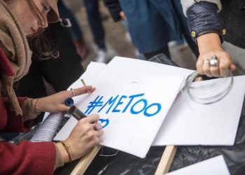 epa06296916 A woman writes the '#Metoo' slogan on a placard during a rally against gender-based and sexual violence against women, in Paris, France, 29 October 2017. The hashtag #MeToo was established in social networks aimed to encourage women to denounce their case of alleged sexual abuse.  EPA/CHRISTOPHE PETIT TESSON