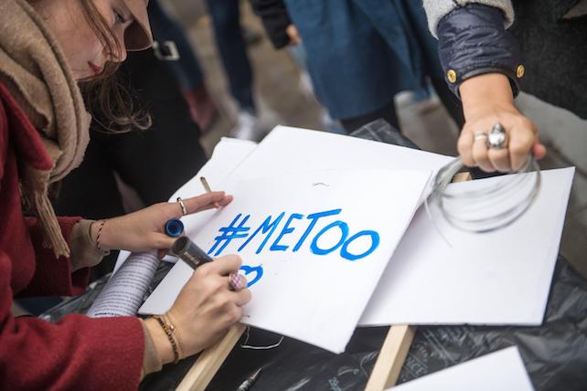 epa06296916 A woman writes the '#Metoo' slogan on a placard during a rally against gender-based and sexual violence against women, in Paris, France, 29 October 2017. The hashtag #MeToo was established in social networks aimed to encourage women to denounce their case of alleged sexual abuse.  EPA/CHRISTOPHE PETIT TESSON