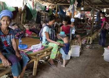 epa06727728 Internally displaced Kachin ethnic people sit inside a temporary refugee camp at Tan Phae village Roman Catholic church in Myitkyina, Kachin State, northern Myanmar, 11 May 2018. Thousands of Kachin ethnic people fled from the renewed fighting between Myanmar Army and Kachin Independence Army (KIA).  EPA/SENG MAI