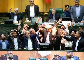 epa06721063 A handout picture made available by the Iranian parliament office shows, members of Iranian lawmakers burn a US flag during the parliament session at the parliament in Tehran, Iran, 09 May 2018. According to reports, Iran said will negotiate over the nuclear agreement with five countries left. US president Donald Trump on 08 May 2018 announced that US will withdraw from the nuclear deal. Foreign ministers from six world powers and Iran finally achieved an agreement to prevent the Islamic republic from developing nuclear weapons, Western diplomats said in Vienna on 14 July 2015.  EPA/HANDOUT  HANDOUT EDITORIAL USE ONLY/NO SALES
