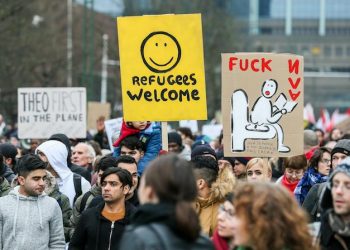 epa06435965 People gather and hold banners reading 'Refugees Welcome' to protest against the migration policy of the Belgian Secretary of State for Immigration, Theo Franken in Brussels, Belgium, 13 January 2018. According to reports, civil society and human rights representatives are calling for the resignation of Theo Francken claiming he failed to respect his mandate and violated the constitution and laws by sending migrants back to their countries to torture, and inhuman and degrading treatment.  EPA/STEPHANIE LECOCQ