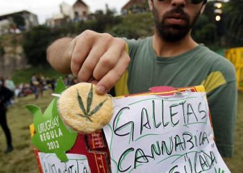 epa04190487 A man sells marijuana cookies at Molino de Perez park after participating in the First World March of Regulated Marijuana, in Montevideo, Uruguay, 03 May 2014. Uruguay legalized the buying and selling and the cultivation of marijuana in the country.  EPA/Ivan Franco