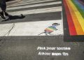 epa06846917 A close-up shows a message of the French organisation for Medically assisted procreation, 'La procreation medicalement assistee' (PMA) that reads, 'PMA for all the love without end' as people walk by rainbow pedestrian crossing decorations in a street of the Marais neighborhood in Paris, France, 28 June 2018. Those crossroad have been restored after being targeted by homophobic vandals. Anne Hidalgo, mayor of Paris, has declared that the Pride decorations stay permanently. The Paris LGBT Pride will take place on 30 June.  EPA/CHRISTOPHE PETIT TESSON