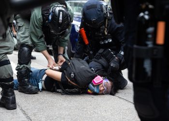 epaselect epa08440822 Police detain a protester during a rally against the implementation of the national security law in Hong Kong, China, 24 May 2020. Beijing unveiled a resolution at the opening of its annual legislative sessions that will bypass Hong Kong's legislature to outlaw acts of secession, subversion and terrorism in Hong Kong.  EPA/JEROME FAVRE