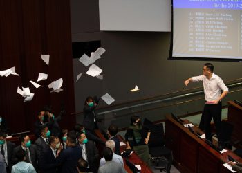 epaselect epa08428864 Pro-democracy lawmakers Lam Cheung-ting (R) throws documents into the air during a scuffle with pro-Beijing lawmakers at a the Legislative Council meeting in Hong Kong, China, 18 May 2020. Several pro-democracy legislators were dragged out of the chamber by security guards as the two camps tussled for control of the House Committee which has been gridlocked for months. The pro-establishment camp called the vote, after most of the pan-democratic lawmakers had been dragged out of the room by security guards after the meeting descended into utter chaos.  EPA/JEROME FAVRE