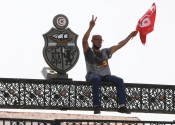 Un manifestante tunisino protesta davanti al Parlamento di Tunisi