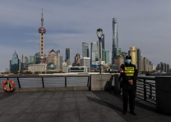 Poliziotto davanti alla skyline di Shanghai