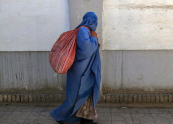 Una donna coperta dal burqa per le strade di Kabul, Afghanistan, agosto 2023