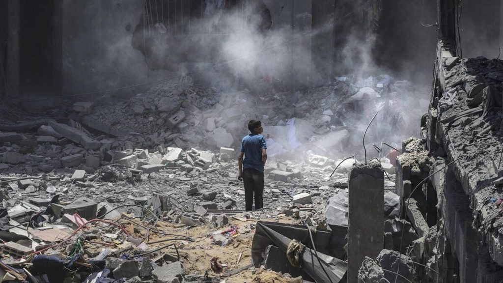 A Palestinian boy walks among the ruins of Gaza