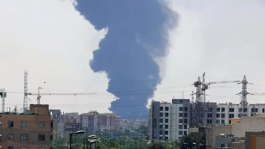 Una colonna di fumo si leva dalla città di Teheran, in Iran, dopo un raid di Israele