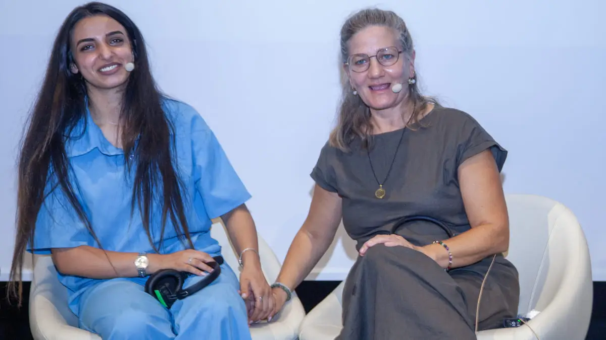 La palestinese Sima Awaad e l’israeliana Maayan Inon i stringono per mano durante in incontro in Italia sulle sofferenze della guerra tra Hamas e Israele