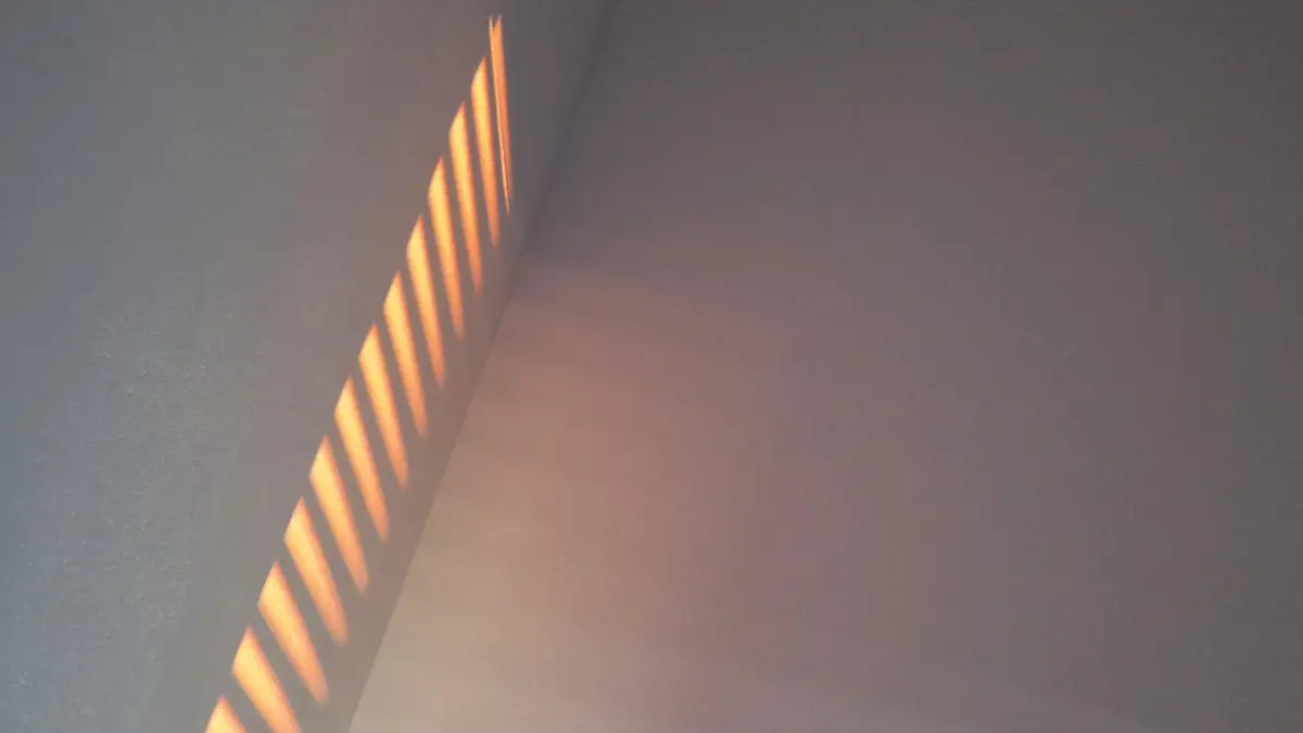 una luce rosa si riflette su una parete
