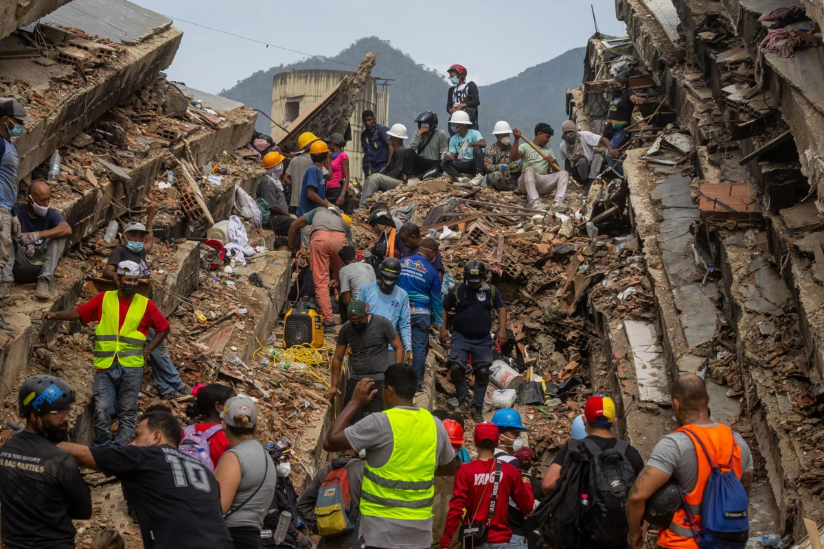 Volontari alla ricerca di sopravvissuti tra le macerie di La Guaira, Venezuela, 30 giugno 2026 (foto Ansa)